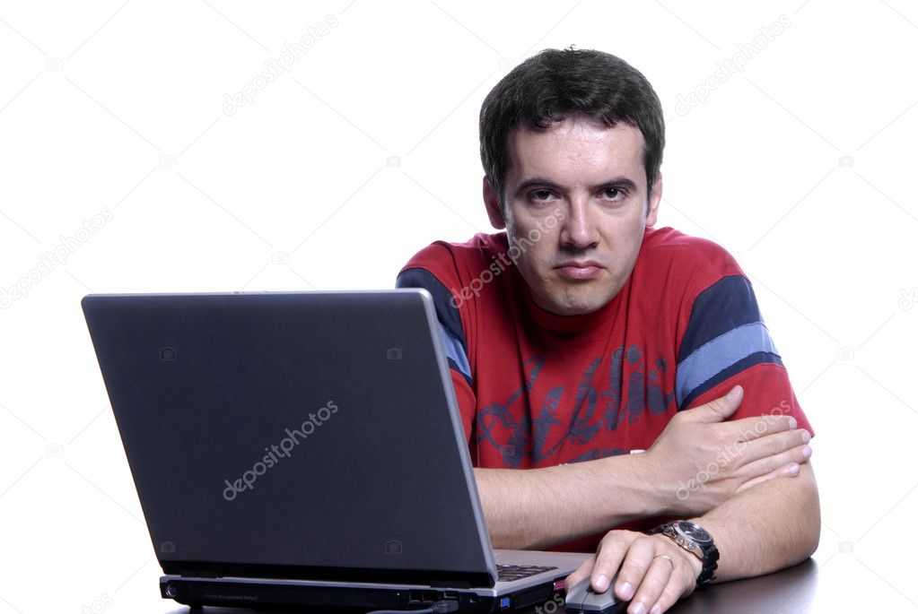 Young sad man working with is laptop