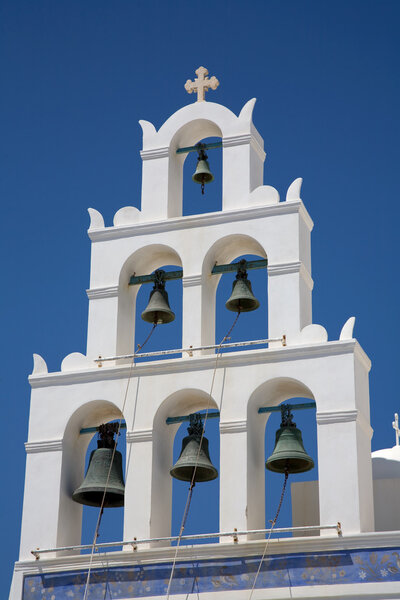 white bell tower in the greek island of santorini