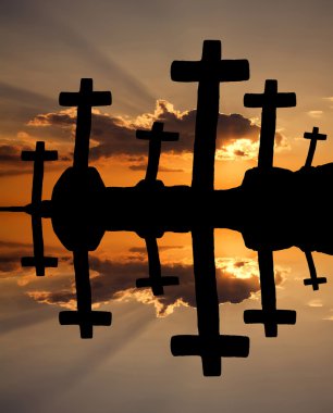 cross at the sunset and the orange clouds clipart