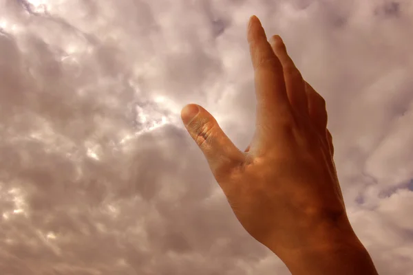 stock image hand in the clouds