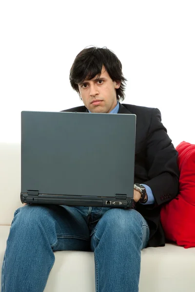 工作与手提电脑在沙发上的年轻人 — 图库照片