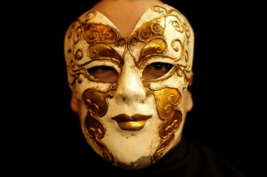 Man with a venice mask in a dark place clipart