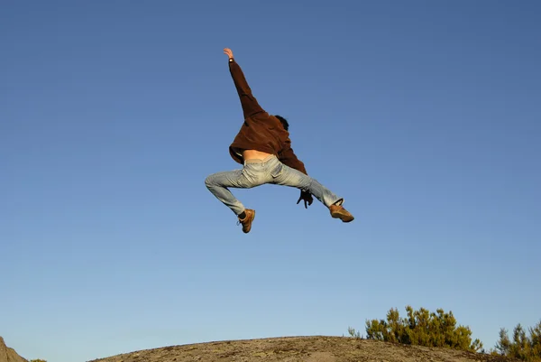 Young Man Jumps High Mountain — Stock Photo, Image