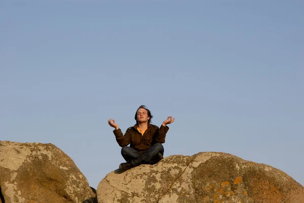 Young Man Meditating While Sitting Rocks Sunset Light — Stock Photo, Image