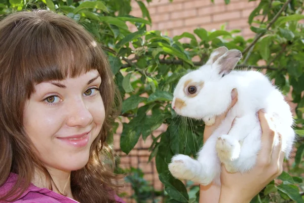 Girl with a white rabbit — Stock Photo, Image