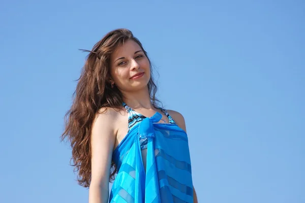 Beautiful girl on a background blue sky — Stock Photo, Image