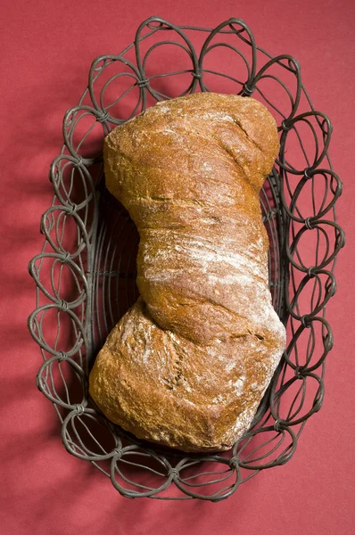 Loaf of bread over color background — Stock Photo, Image