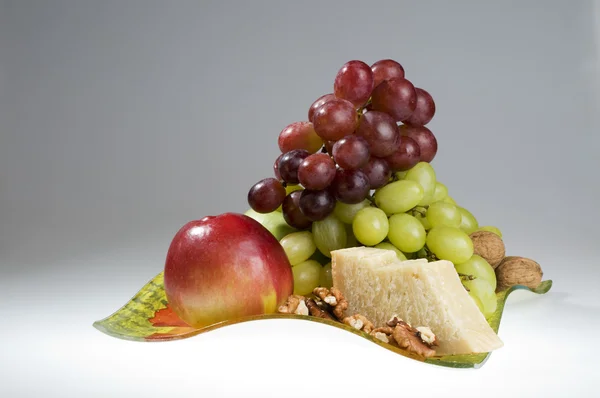 Fructe și brânză întinsă într-o farfurie . — Fotografie, imagine de stoc