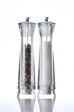 Salt and pepper mills on white clipart