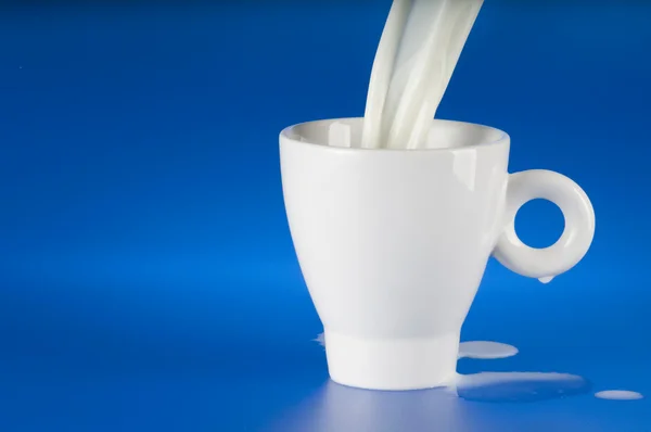 Stream Milk Being Poured Cup Blue Background — Stock Photo, Image