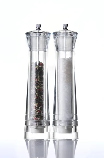 Salt and pepper mills on white — Stock Photo, Image