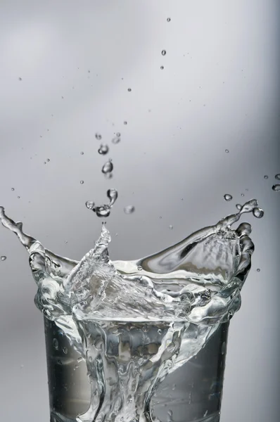 Zoet water spatten uit een glas met ijs — Stockfoto