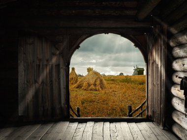 Open gates of old house with view to the field clipart