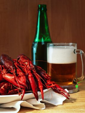 Red boiled crawfishes and mug of beer clipart