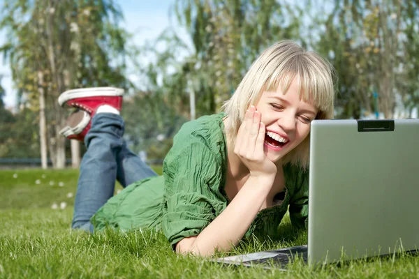 Mulher em um parque com laptop — Fotografia de Stock