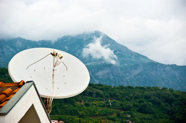 stock image Satellite dish, roof and mountains