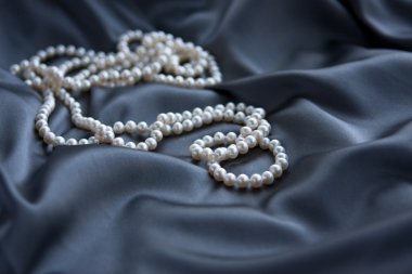 White pearls on blue satin clipart