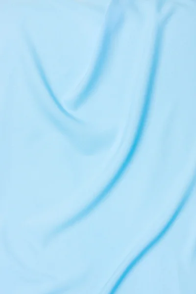 Niebieskim tle satyna — Zdjęcie stockowe