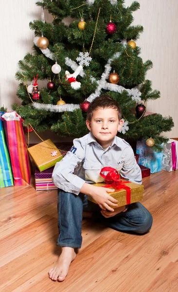 Chlapec u vánoční strom — Stock fotografie