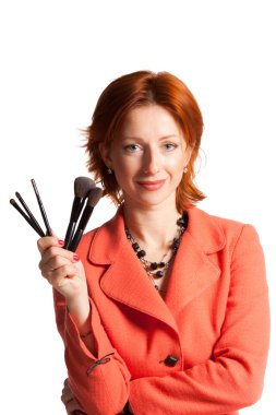 Woman with brushes for a make-up in hands clipart