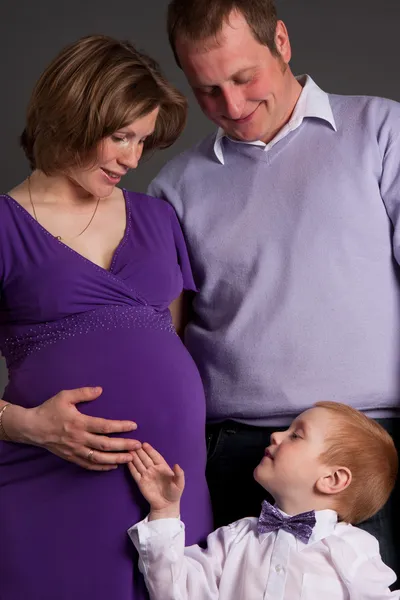 Happy family with cute boy expecting another baby — Stock Photo, Image