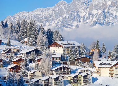 Winter holiday houses in swiss alps clipart