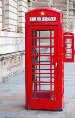 Red telephone booth in London clipart