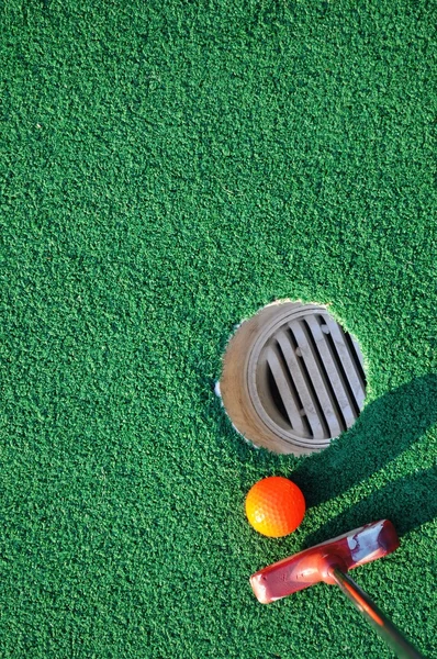 Pole do mini golfa i tło zielony — Zdjęcie stockowe