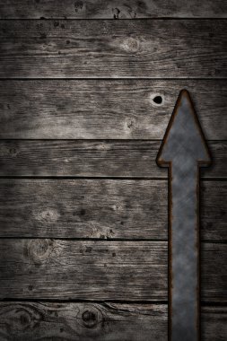 Rusty arrow on wooden background clipart