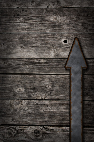 Rusty arrow on wooden background