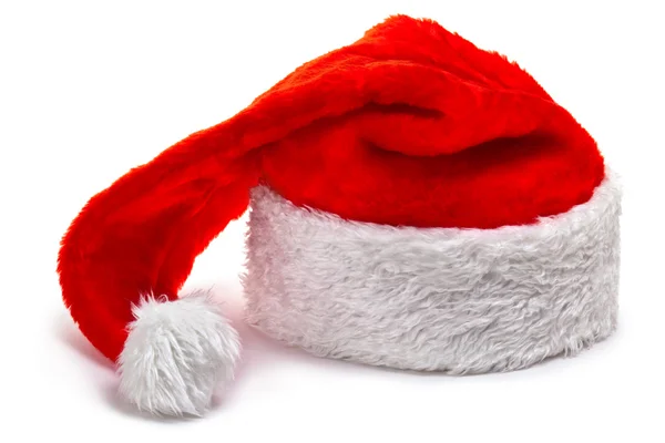 Санта Клауса капелюх, лежачи на білий — стокове фото