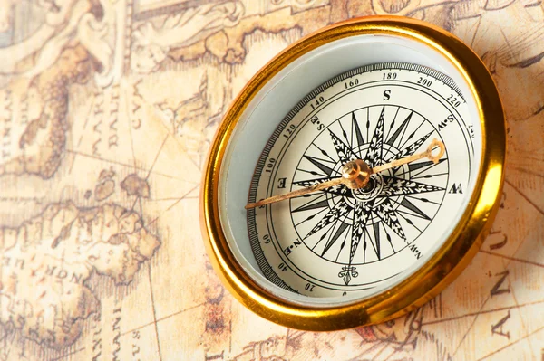 Old compass on ancient map — Stock Photo © galdzer #5198684