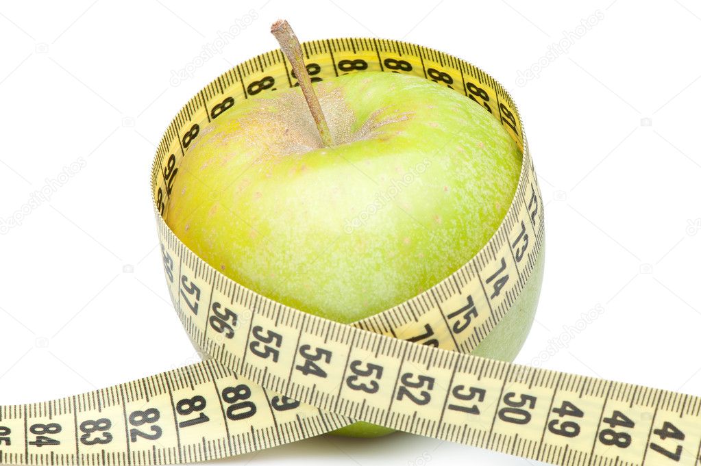 Closeup of a green apple with a measuring tape. Isolated on whit
