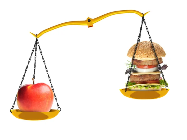 Scales with an apple and a hamburger — Stock Photo, Image