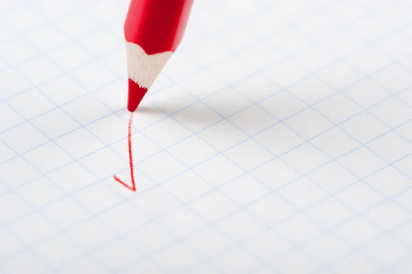 Red pencil writing a mark — Stock Photo, Image