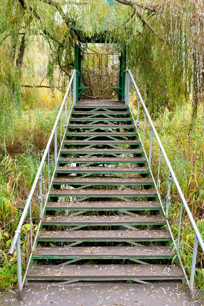 Iron ladder in summer house above a reservoir — Stock Photo, Image
