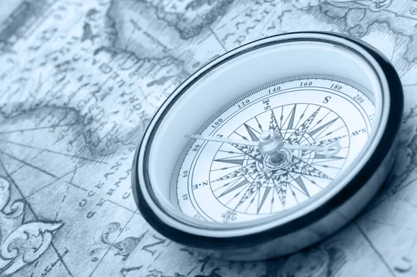 Old compass on ancient map — Stock Photo, Image