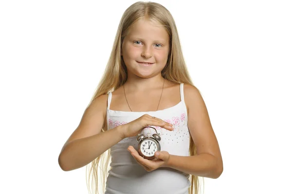 The girl holds an alarm clock in hands — Stock Photo, Image