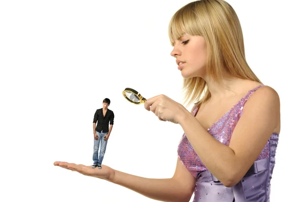 The girl considering the guy through a magnifier.The potential g — Stock Photo, Image