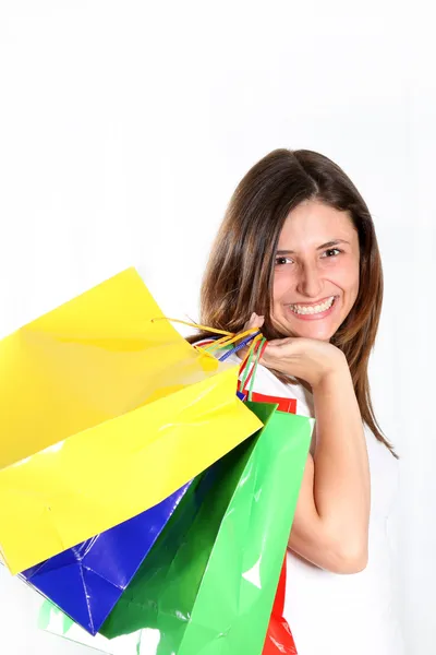 Gelukkige vrouw komt met kleurrijke tassen — Stockfoto