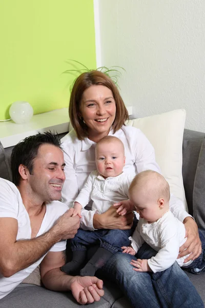 Unga föräldrar - mamma, pappa och tvillingar — Stockfoto