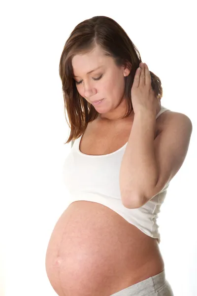 Schwangere Frauen Junge Frau Vor Weißem Hintergrund Sieht Auf Ihrem — Stockfoto