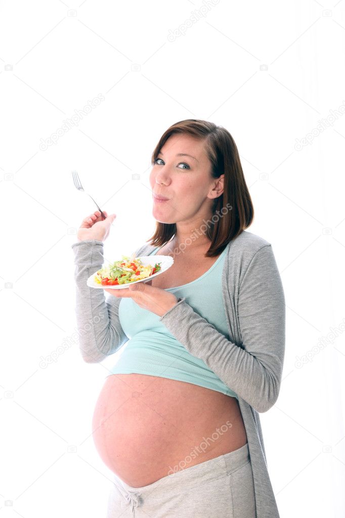 Pregnant woman eating salad healthy
