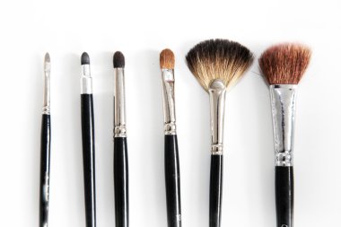 Various brushes for makeup in a row clipart