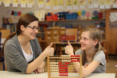 Teacher and students laugh at themselves and show a thumbs up clipart