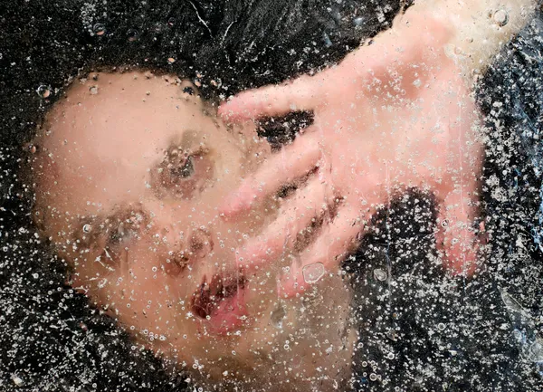 Man Trapped Under Ice with Hand on Ice Stock Image