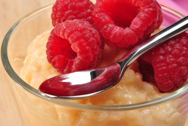 Home made creamed rice pudding with raspberries clipart