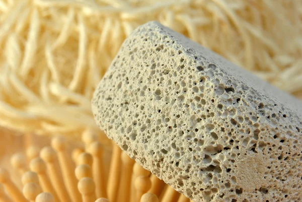 Cepillo para el cabello en una toalla de tela de rizo y piedra pómez — Foto de Stock