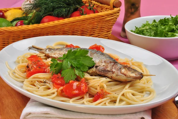 Grilled organic sardine on some tomato spaghetti — Stock Photo, Image