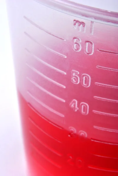 30 ml red liquid as medicine in a small container — Stock Photo, Image